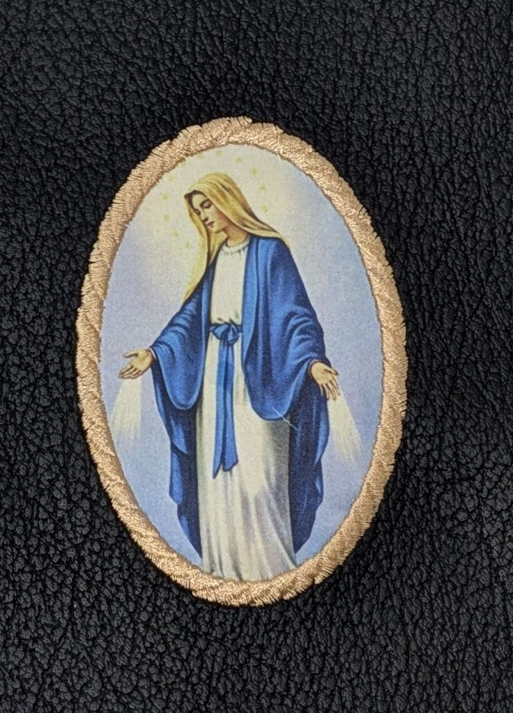 Our Lady of Grace embroidered medallion design available as an optional cover image