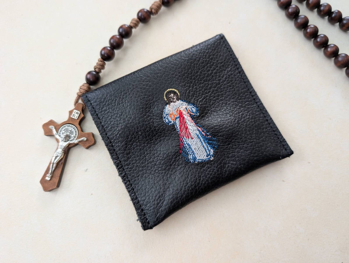 Medium Divine Mercy leather rosary pouch surrounded by a rosary, shown for display purposes only; rosary not included